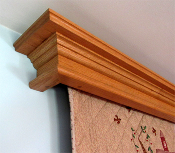 Close up view  of a Federal style wall mounted quilt hanger