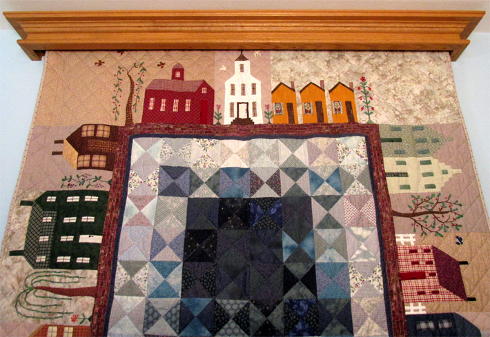 Front full width view of a mission style quilt hanger, with attached quilt, made from plans