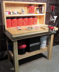 Picture of an ammunition reloading bench, with  interchangeable bullet press, made from plans.