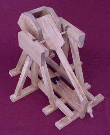 Top back view of a working model desktop trebuchet in the cocked position looking into the counterweight cabinet