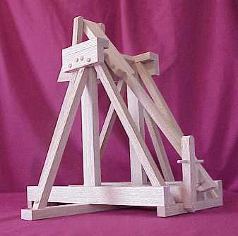 Back view of a working scale model trebuchet showing the trigger and release pin.