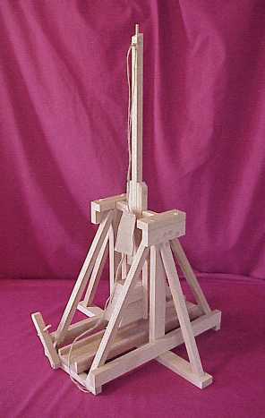 Side view of a working scale model trebuchet in the fired position showing the sling with pouch.