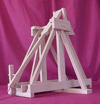 Back view of a working scale model trebuchet in the cocked positon showing the trigger and release mechanism.