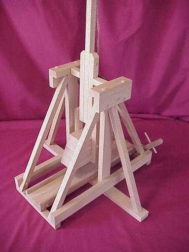 Front view of a working model trebuchet in the fired position.