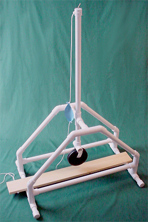 Side view of PVC trebuchet in the fired positon showing the sling and empty pouch