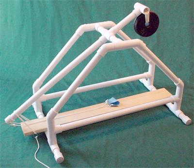 Side view of a PCV pipe golf ball trebuchet in the cocked, or ready, position