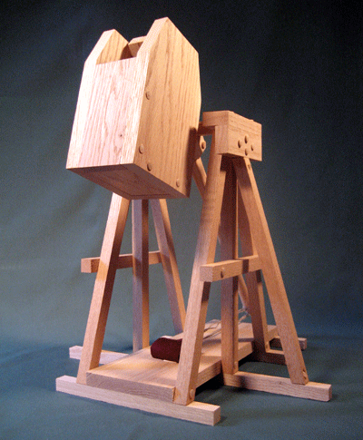 Lower front view of a trebuchet showing the counterweight swung to the stop