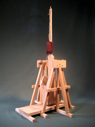 Side view of a trebuchet in the fired position showing the sling and pouch