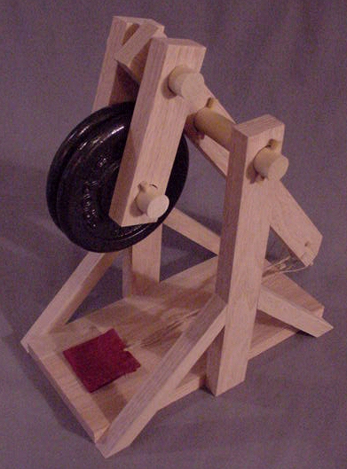 Top left overhead view of a working model trebuchet, made from plans, in the cocked position