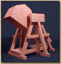 Side view of a working model trebuchet in the cocked position.