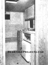 Interior view shows sink, closet and lower bunk before finishing. Note refrigerator under stove.