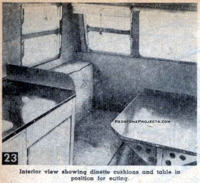 Interior view showing travel trailer dinette cushions and table in position for eating.