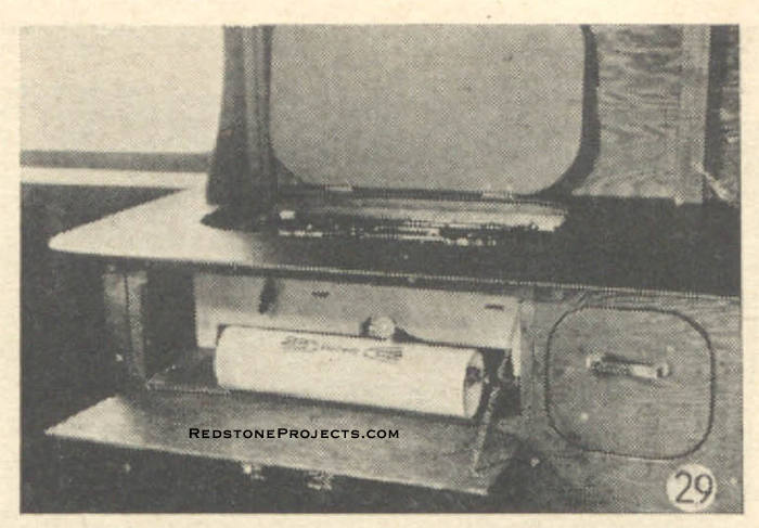 Fig. 29. Stove compartment with hinged door and cover. Stove may be removed for cooking outdoors.