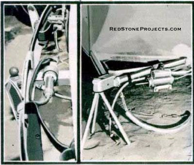 Car hitch arrangement, showing ball at end of drawbar. Note the double cylinder hydraulic brake unit and mount pin for car unit.Tubular tripod supports front of trailer and auxilary chain, required by law, adds safety.