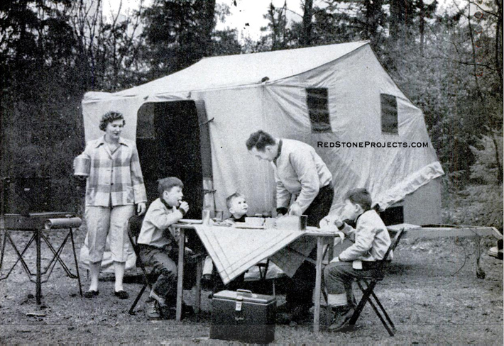 Family at breakfast outside a DIY tent trailer