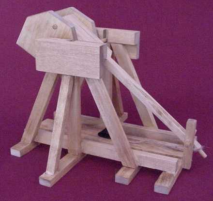 Trebuchet Plans - Side view of a working model tabletop trebuchet in the cocked position.