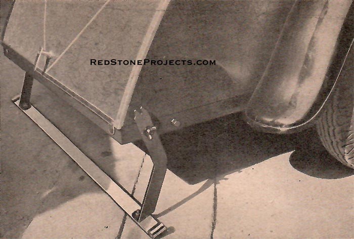 The special bumper of the trailer, which can be let down when you reach camp to furnish support at rear. It is held in position by wing nuts.