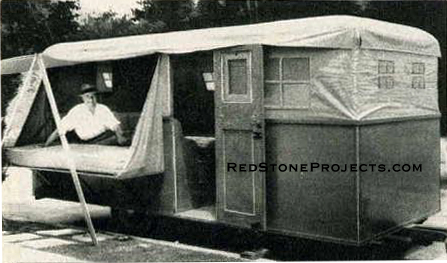 Sir Guy Standing rests on the open bunk of his trailer. The tent poles hold the bunk flap up.