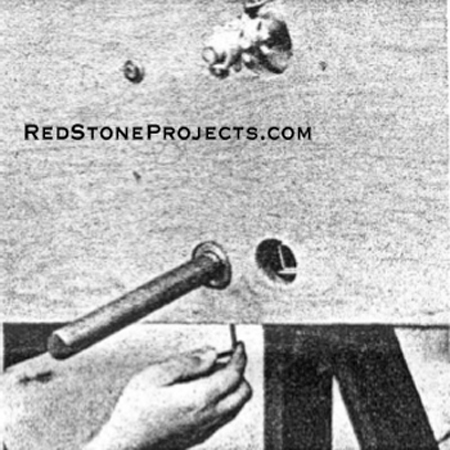 ALLEN KEY tightens axle locating collar working through access hole in plywood.