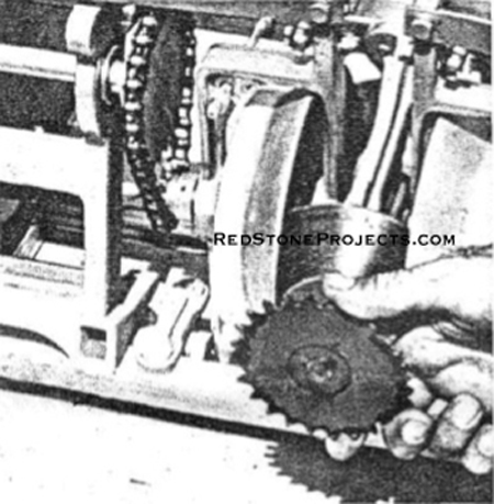 FLEXIBLE COUPLING at rear of TAT hooks up to front of 8-hp engine output shaft.