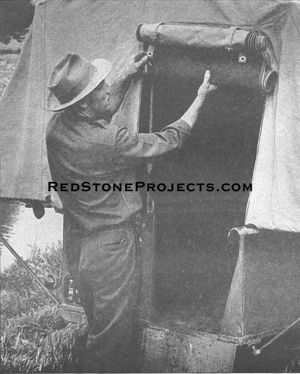 Lower tails are snap-fastened to the sides of the end gate door.