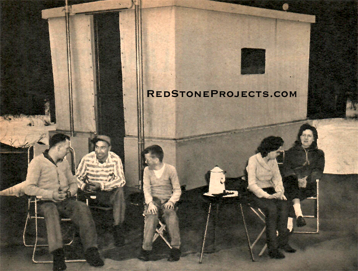 Crank up hardtop canvas camping trailer set up at campsite.