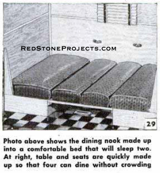 Vintage travel trailer dinette folded to make a bed.