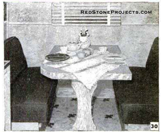 Travel trailer dinette table set for dinner.