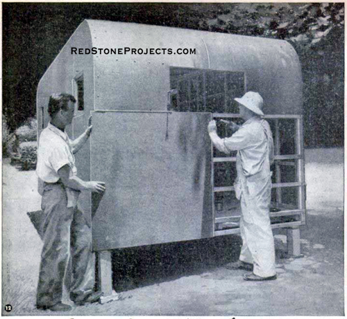 Installing the exterior skin on a travel trailer.