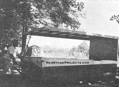 Next the lever is brought around to the rear of the trailer and the rear end of the roof is raised.