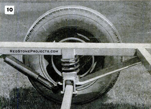 Axle, wheel and suspension for a folding camper trailer chassis.