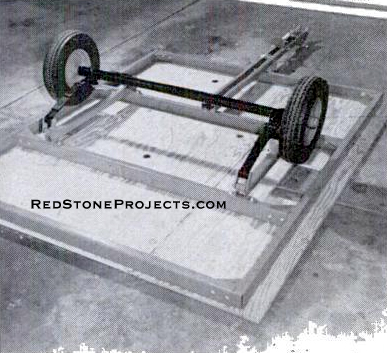 Upside-down, trailer chassis is positioned on camper floor so you can  mark for Tee nut holes. Trailer detaches for other uses.