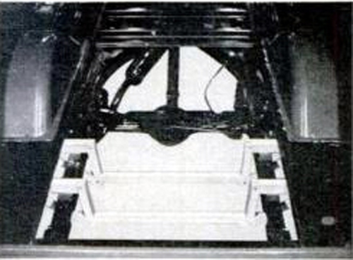Sump Framework in Chevy pickup must replace channel irons and spare tire brackets. Oak frame with half-lapped joints is held together with carriage bolts and waterproof glue. Treat with pentachlorophenol.