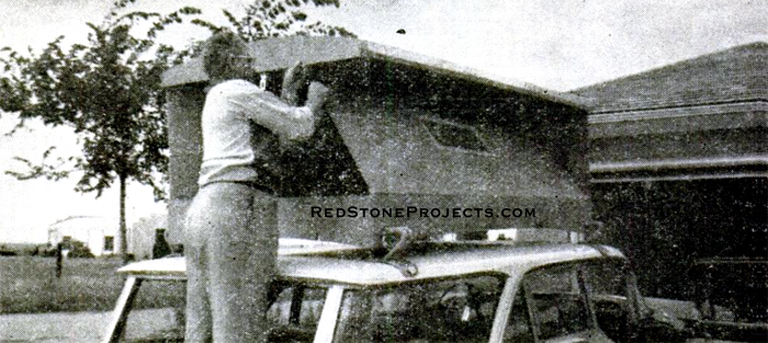 LIFTING THE ROOF at the rear and swinging the hinged sides up to support it is the next step. With solid footing on the tailgate of the wagon, both hands are left free to work.