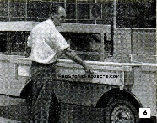 Pulling out the sliding sidewall floor of a DIY folding camper trailer.