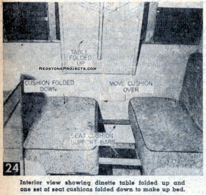 Interior view of the camping trailer showing the dinette table folded up and one set of seat cushions folded down to make up bed.