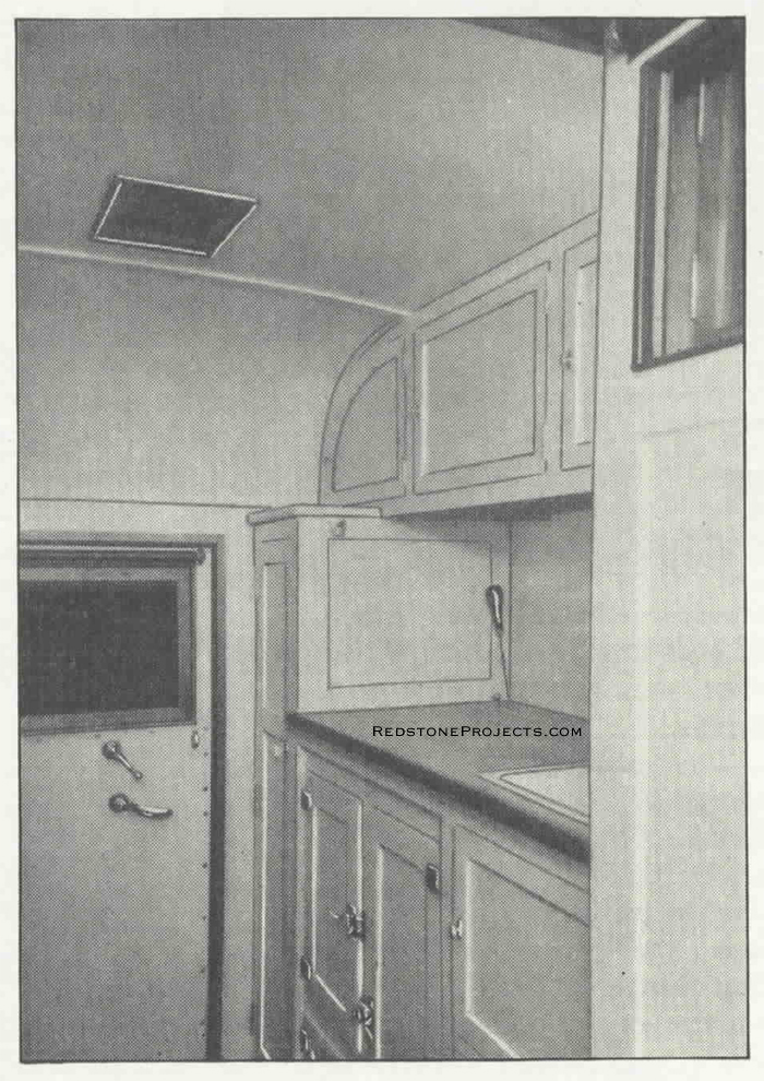 An interior view showing the compact and convenient arrangement of the kitchen. Rear door shown.