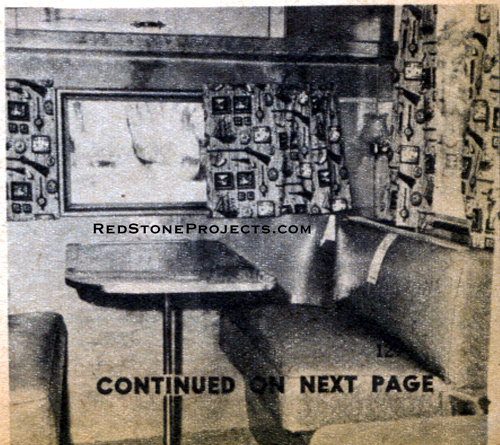 Photo of the interior of a canned ham trailer showing the fold down table and pullman-style seats of the sleeper and dinette.